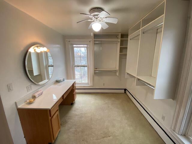 227 Railroad St, Chelsea, MI 48118 - bathroom featuring a baseboard radiator, ceiling fan, and vanity