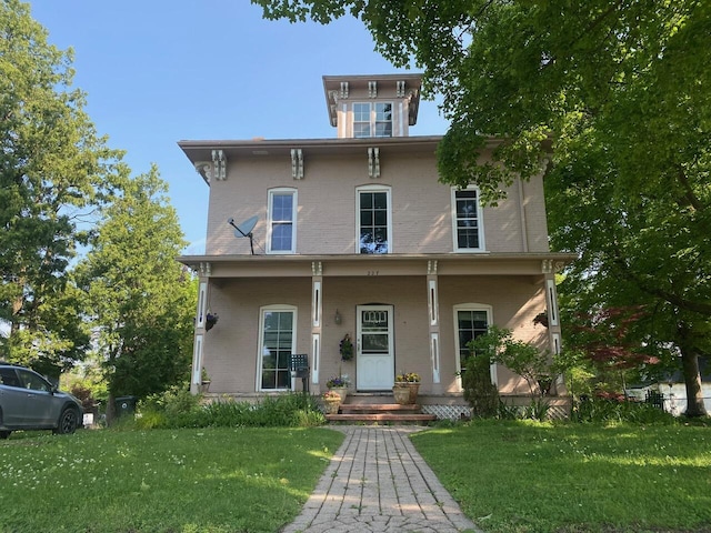 227 Railroad St, Chelsea, MI 48118 - italianate house with a front lawn, brick siding, and covered porch