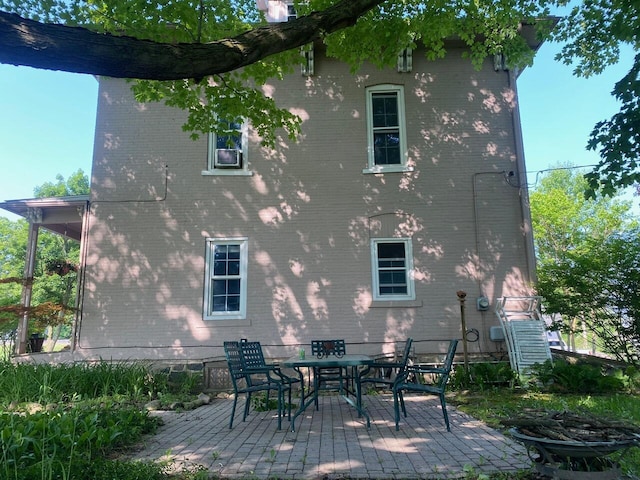 227 Railroad St, Chelsea, MI 48118 - back of property with brick siding and a patio