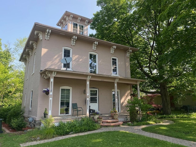 227 Railroad St, Chelsea, MI 48118 - italianate home with covered porch, brick siding, and a front lawn