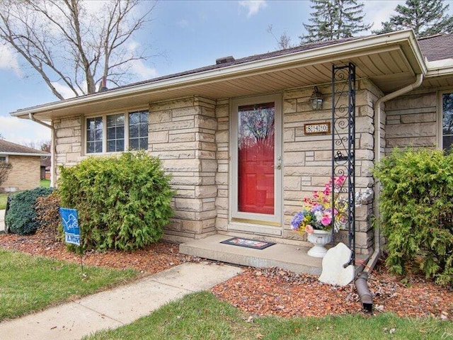 property entrance featuring stone siding