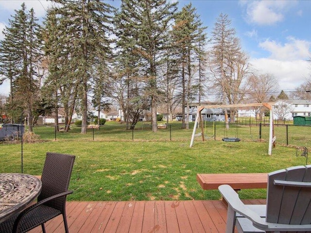 deck featuring fence, a yard, and a residential view
