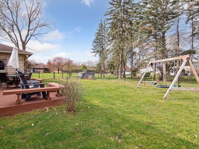 view of yard featuring a playground and fence