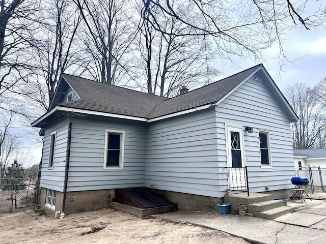 4480 Stanton Blvd, Montague, MI 49437 - exterior space featuring a shingled roof, fence, a gate, and entry steps