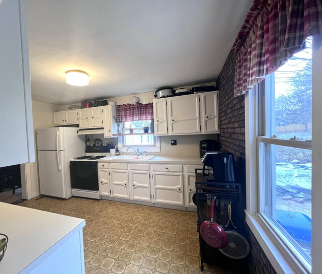 4480 Stanton Blvd, Montague, MI 49437 - kitchen featuring light countertops, a sink, freestanding refrigerator, light floors, and gas stove