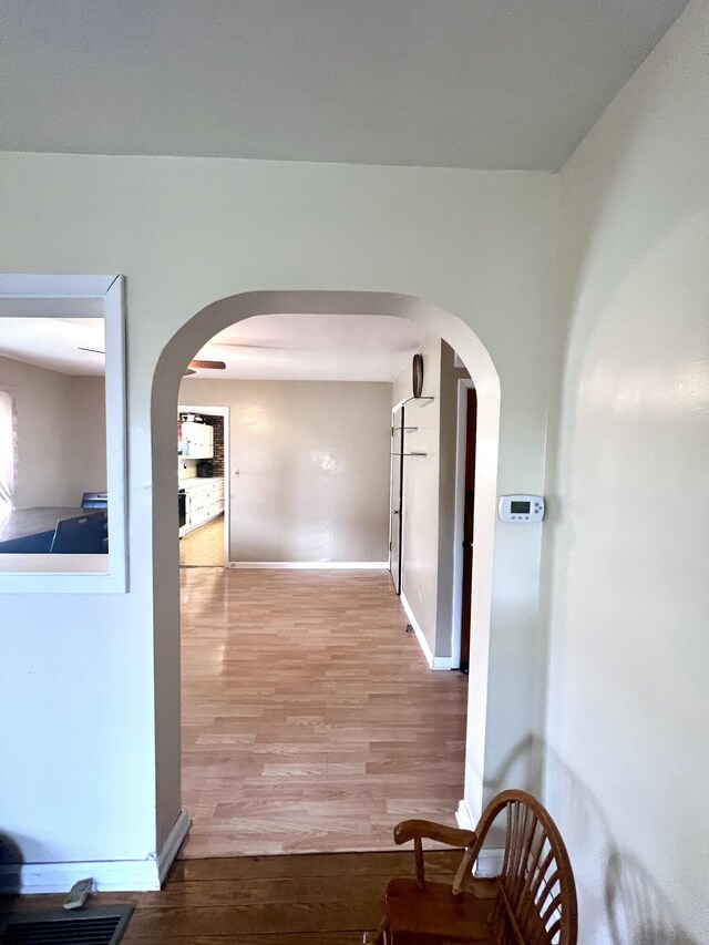4480 Stanton Blvd, Montague, MI 49437 - corridor with baseboards, arched walkways, and wood finished floors