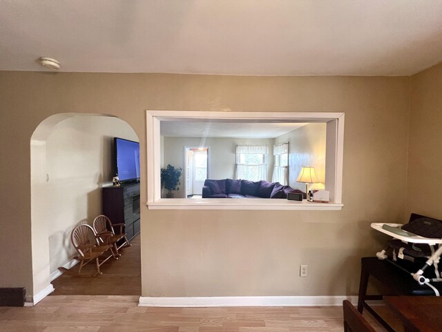 4480 Stanton Blvd, Montague, MI 49437 - interior space with baseboards, arched walkways, and wood finished floors