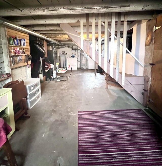 4480 Stanton Blvd, Montague, MI 49437 - unfinished below grade area with water heater, stairway, and washer / dryer