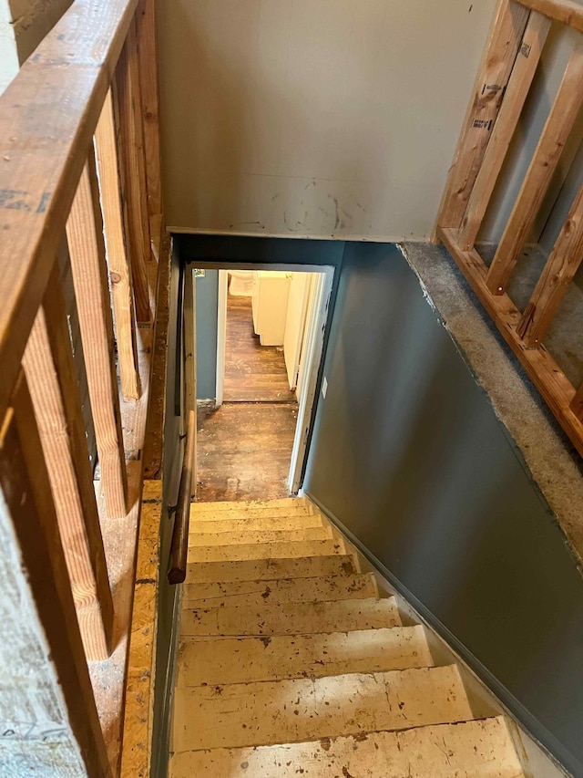 staircase with wood finished floors