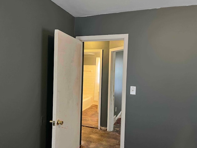 corridor featuring unfinished concrete flooring