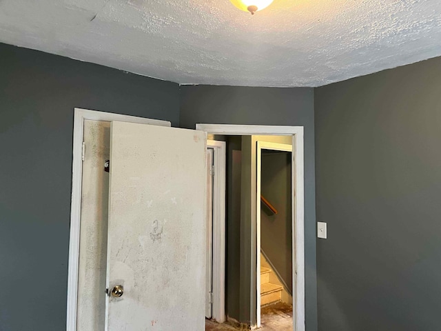 unfurnished bedroom with a textured ceiling