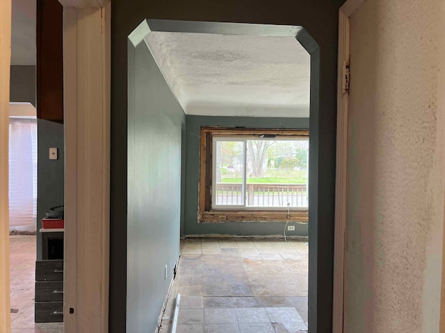 hall with a textured ceiling