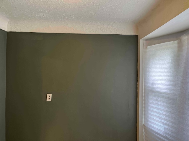 spare room with a textured ceiling