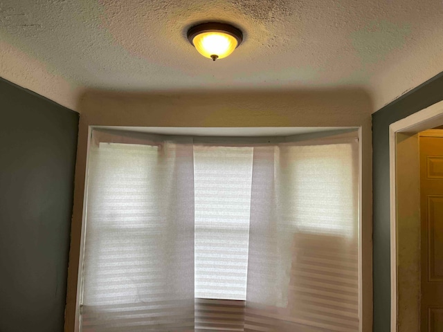 unfurnished room featuring a textured ceiling