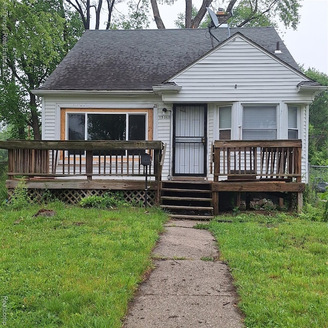15368 Greydale St, Detroit, MI 48223 - view of front facade featuring roof with shingles, a front lawn, and a wooden deck