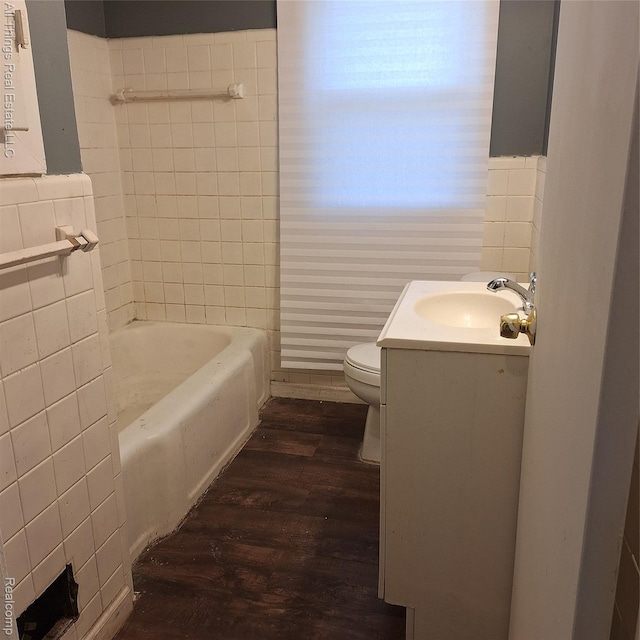 15368 Greydale St, Detroit, MI 48223 - bathroom featuring wood finished floors, tile walls, a tub to relax in, and vanity