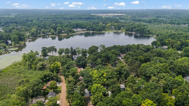 aerial view with a forest view and a water view