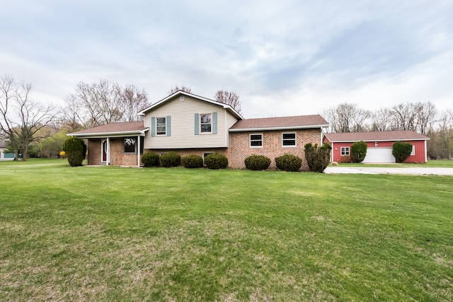 split level home with concrete driveway, brick siding, and a front lawn