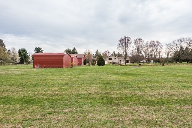 view of yard featuring an outbuilding and a shed