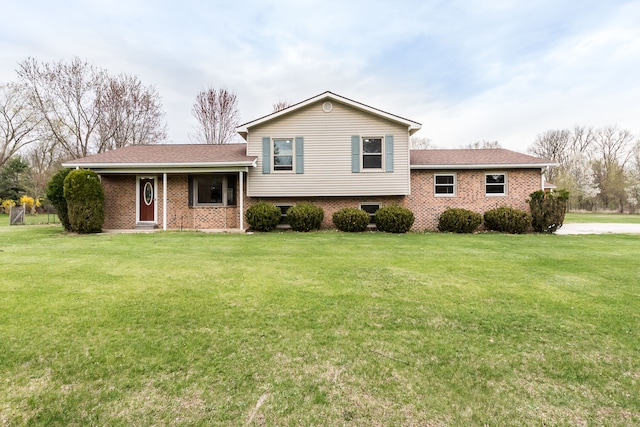 split level home with brick siding and a front lawn
