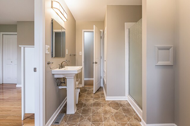 full bath featuring baseboards, visible vents, and a stall shower