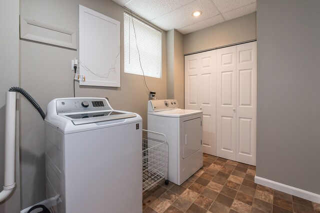 washroom featuring independent washer and dryer, laundry area, baseboards, and stone finish floor