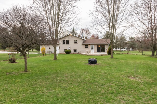 rear view of property featuring a wooden deck and a yard