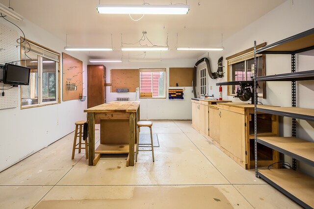 kitchen featuring open shelves, concrete floors, and butcher block counters
