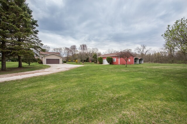 exterior space featuring an outdoor structure, dirt driveway, and an attached garage