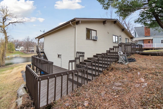 view of property exterior featuring a deck with water view