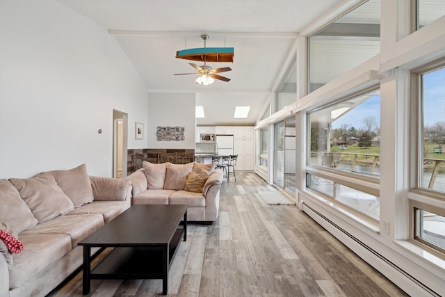living room with light wood finished floors, baseboard heating, high vaulted ceiling, and a ceiling fan