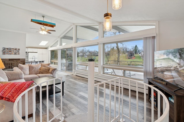 sunroom / solarium featuring lofted ceiling with beams and wood finished floors