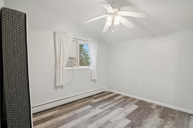 unfurnished room with vaulted ceiling, baseboard heating, baseboards, ceiling fan, and wood finished floors