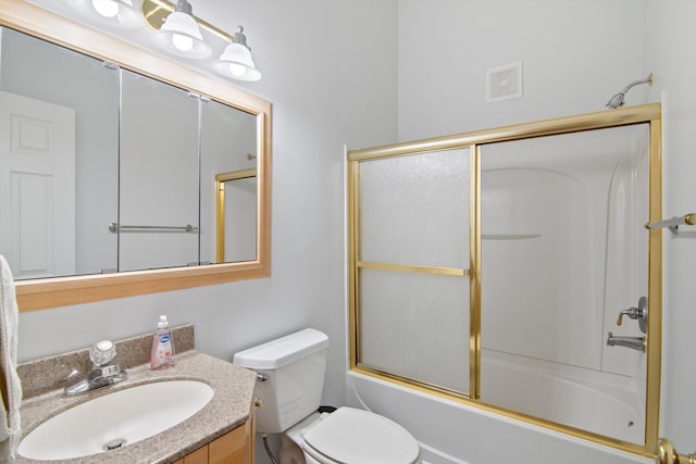 bathroom with toilet, vanity, shower / bath combination with glass door, and visible vents