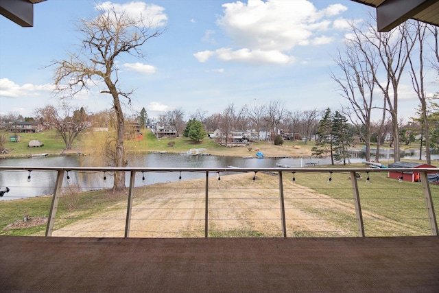 view of yard with a water view and fence