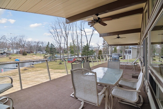 view of patio with a balcony, a grill, outdoor dining space, and a ceiling fan
