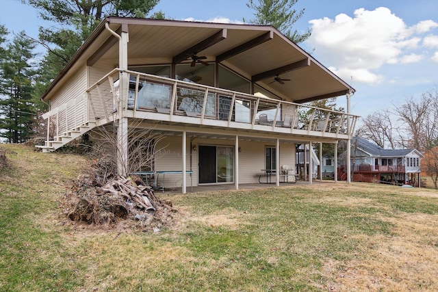 back of house with stairs, a patio, a deck, a ceiling fan, and a yard