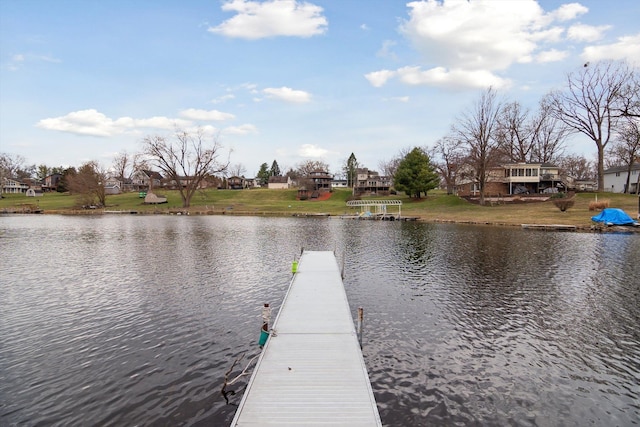 view of dock featuring a water view and a yard