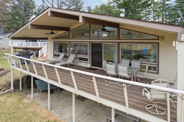 exterior space featuring ceiling fan and stairway