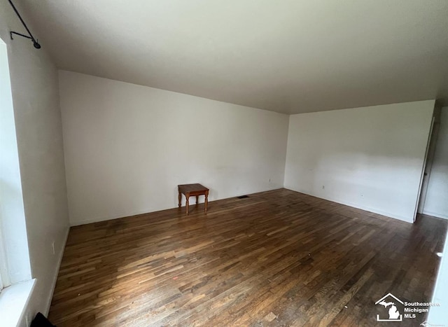 empty room with wood finished floors