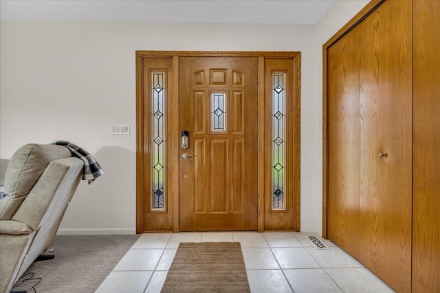 entrance foyer featuring light tile patterned floors, visible vents, and baseboards