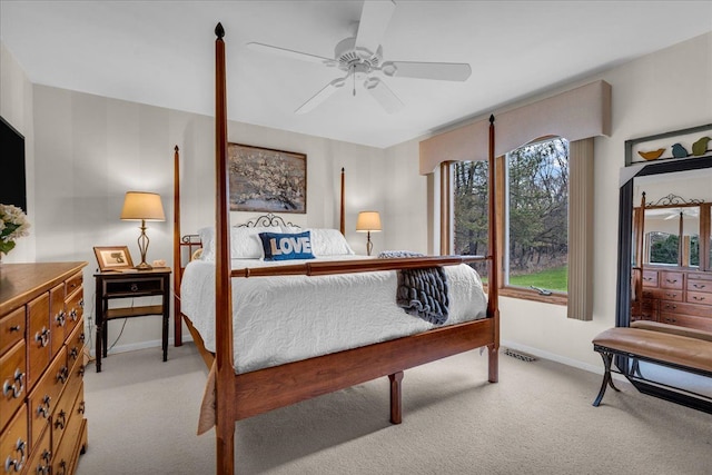 carpeted bedroom with visible vents, ceiling fan, and baseboards