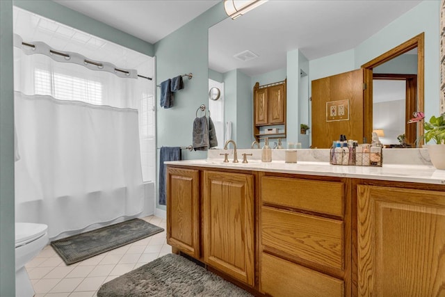 full bathroom with toilet, shower / bath combo with shower curtain, vanity, and tile patterned flooring