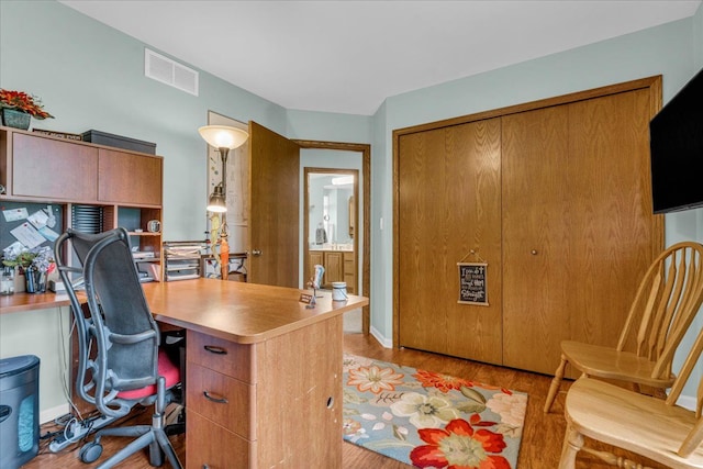 office with visible vents and light wood-style flooring
