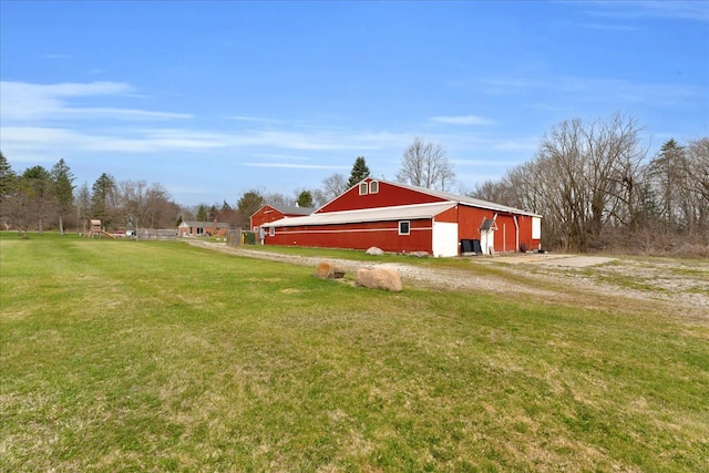 exterior space with a garage, an outdoor structure, and an outbuilding
