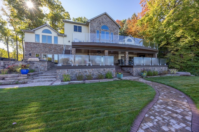 8366 Lynwood Ln, Mecosta, MI 49332 - back of property with stone siding, stairs, a lawn, and a balcony
