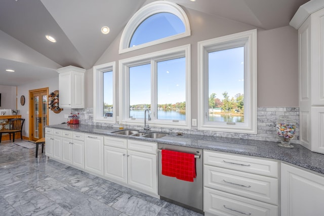 8366 Lynwood Ln, Mecosta, MI 49332 - kitchen featuring lofted ceiling, stainless steel dishwasher, marble finish floor, a sink, and white cabinets