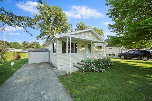 bungalow-style house featuring an outdoor structure, a shed, and a front yard