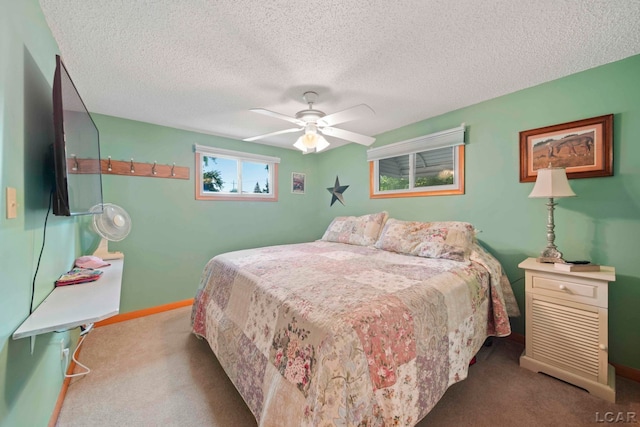 bedroom with carpet floors, a ceiling fan, a textured ceiling, and baseboards