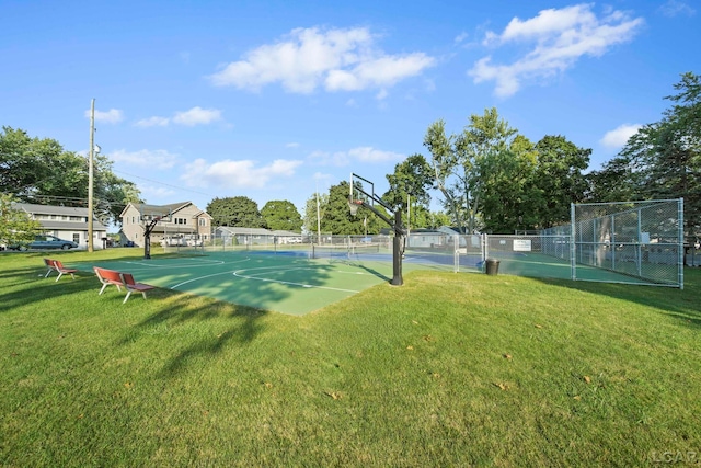 view of sport court featuring fence, community basketball court, and a lawn